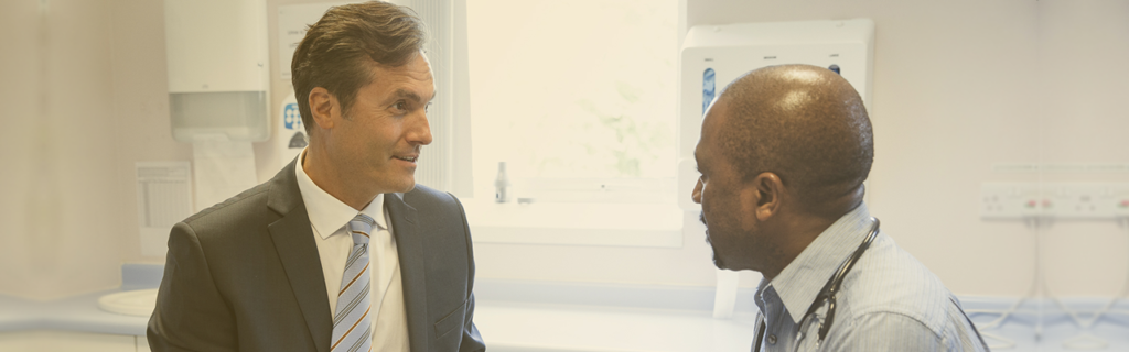 A provider talks to a man inside a Premise Health center