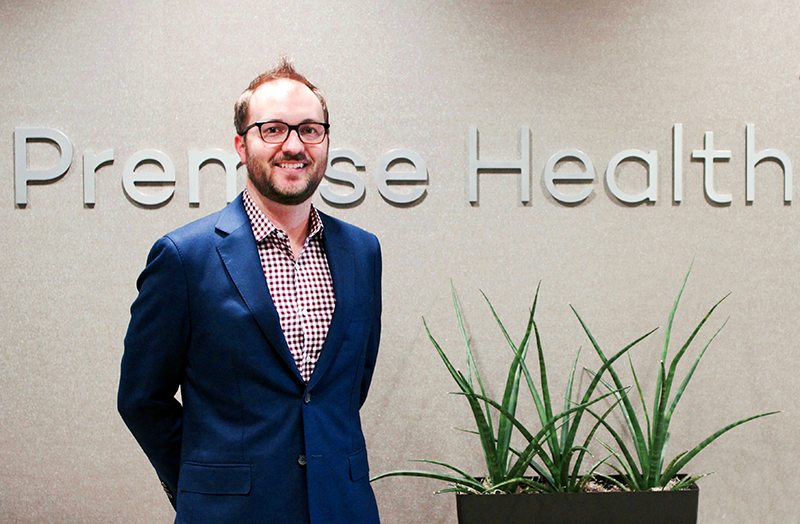 Tom Waddell in front of the Premise Health logo