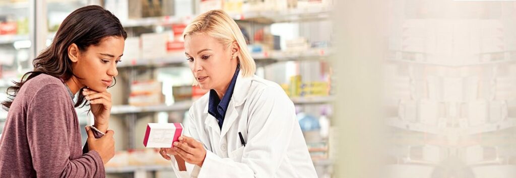 A pharmacist discusses a prescription with her patient