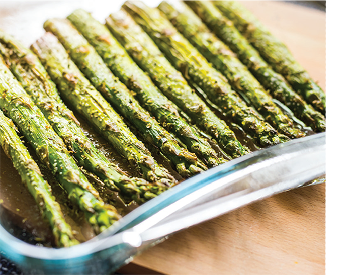 A dish holds grilled asparagus