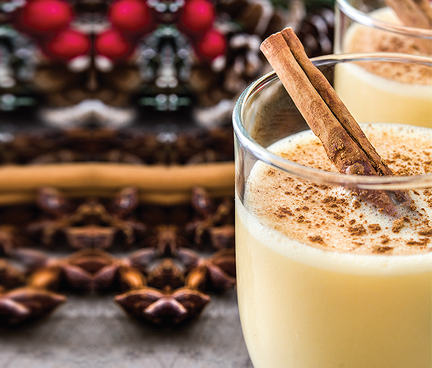 A glass of healthy eggnog with cinnamon sticks